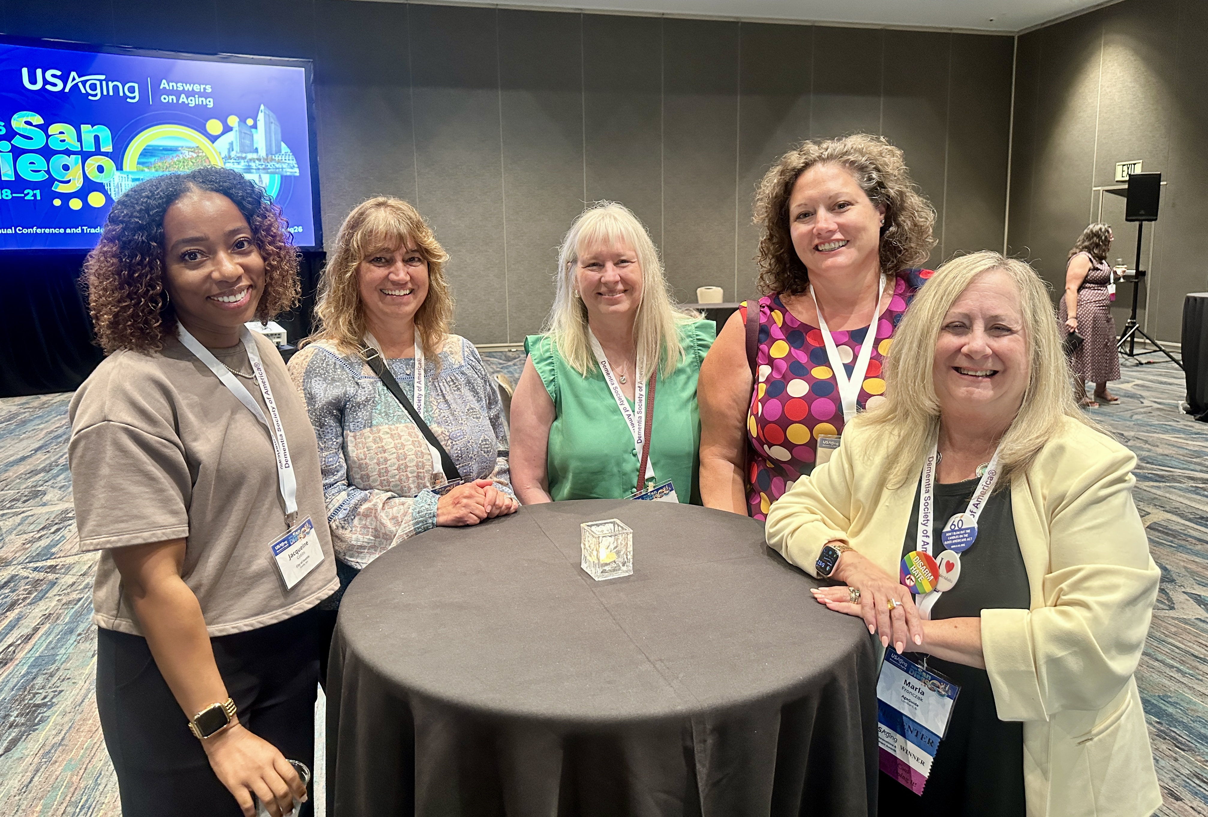 A table of attendees, six women and one man, engage in a lively discussion during a roundtable session at the Conference. A table of attendees, six women and one man, engage in a lively discussion during a roundtable session at the Conference.